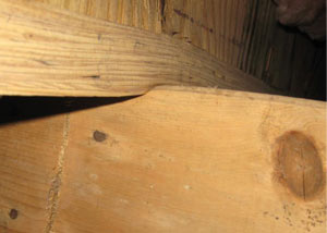 A failing girder showing signs of compression damage in a Long Island home