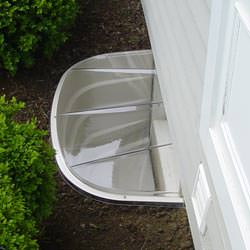 A vinyl basement window and covered window well in Bellmore