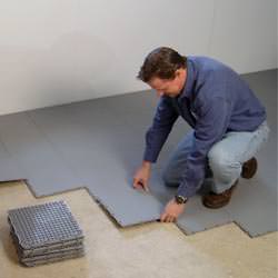 basement subfloor tiles being installed by a contractor in Central Islip
