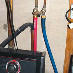 Washer hoses in a basement  in Suffolk County