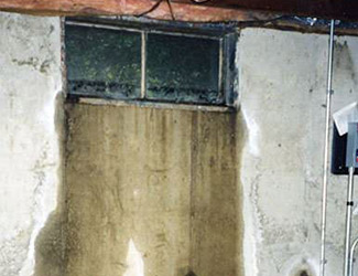 Water pouring out from a basement window in Smithtown