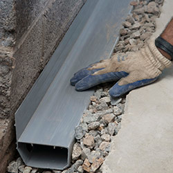 installing a drain tile system in a East Meadow home